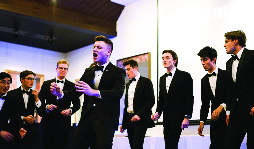 Candid image of Trinity's a capella group Tiger Tones performing on the stage.