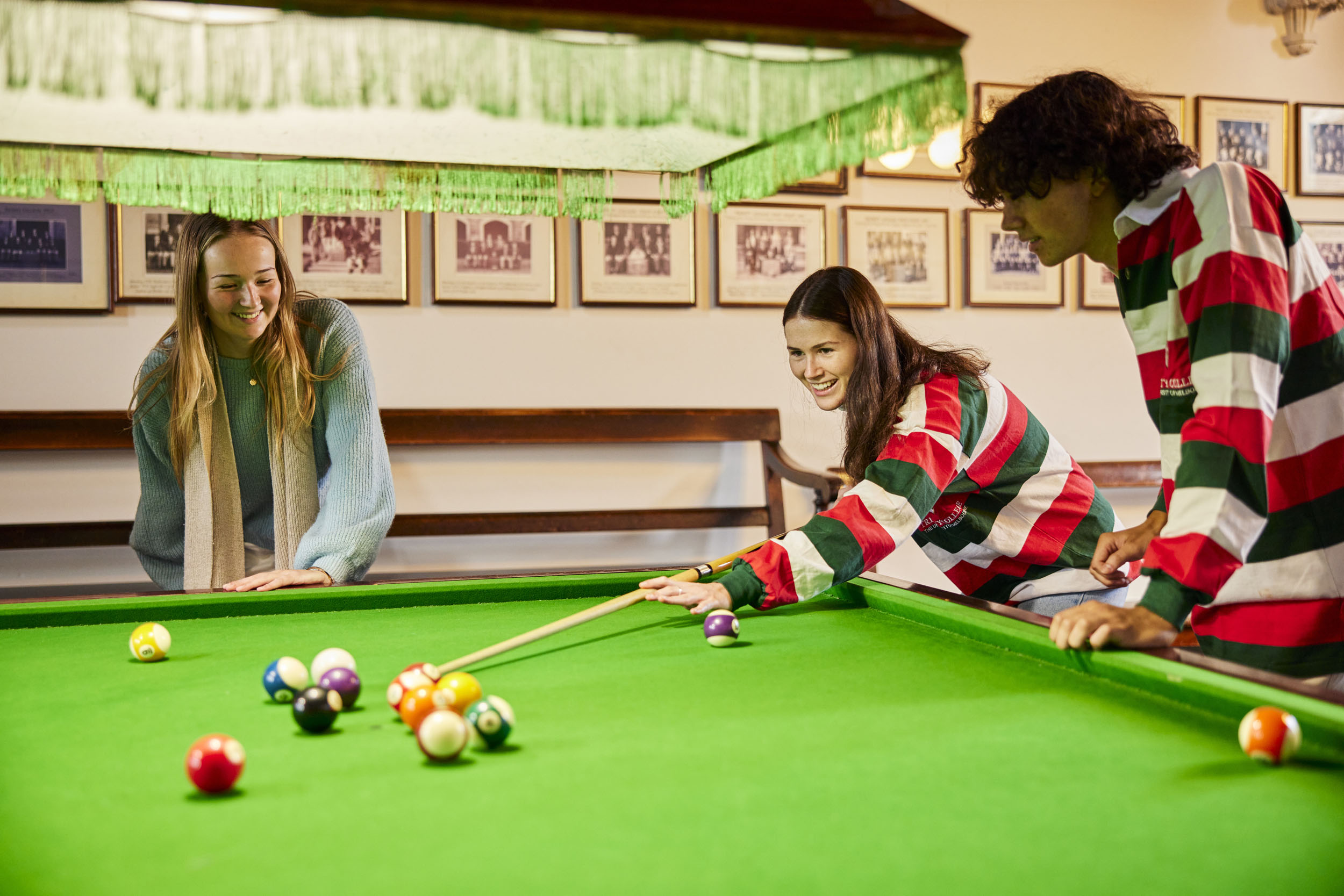 Students playing billiards