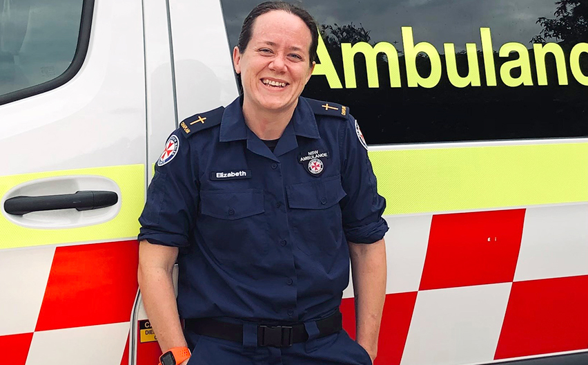 Elizabeth Thompson standing outside an ambulance vehicle